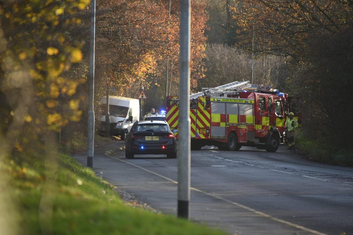 Van collides into lamppost after crash blocks busy road in both directions