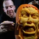 Pumpkin carver Simon McMinnis with one of his masterpieces