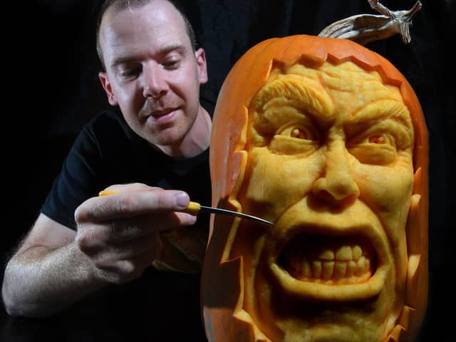 Pumpkin carver Simon McMinnis with one of his masterpieces