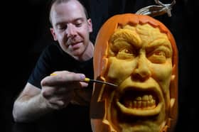 Pumpkin carver Simon McMinnis with one of his masterpieces
