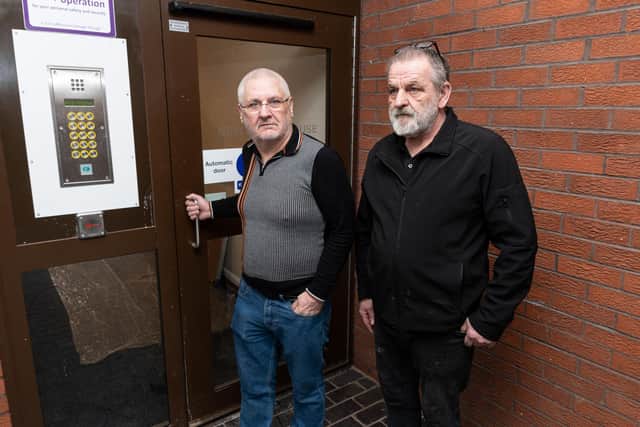 John Fraser and Gary Burgess outside the security door which is broken