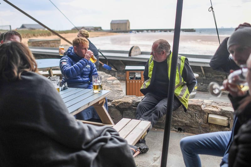 A group of people having a drink outside n Elie, Fife. (Photo by Peter Summers/Getty Images)