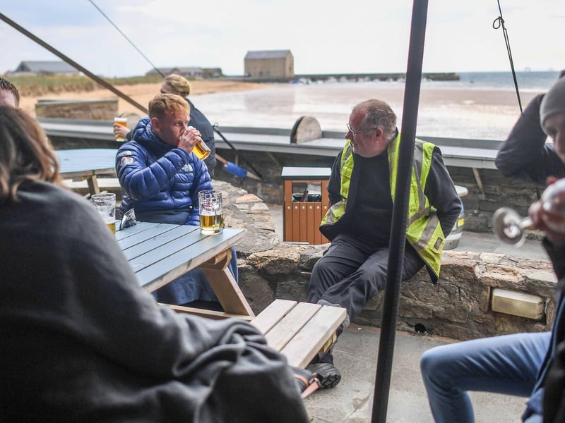 A group of people having a drink outside n Elie, Fife. (Photo by Peter Summers/Getty Images)