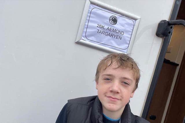Leo Ashton, 14, and from Chorley, stars as young Aemond Targaryan in HBO's House of the Dragon. Pictured outside his trailer on set