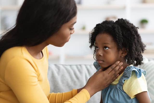 The symptoms of scarlet fever include a sore throat, headache, fever, nausea and vomiting. This is followed by a fine red rash, which typically first appears on the chest and stomach, rapidly spreading to other parts of the body