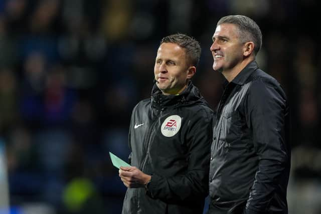 Preston North End manager Ryan Lowe has a word with fourth official David Webb at Huddersfield Town.