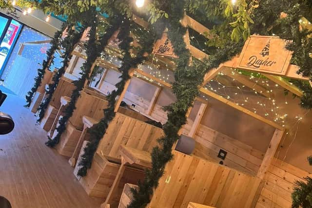 Fashioned after a cosy, winter lodge, the wood-panelled bar will feature six booths – each with its own TV screen showing classic Christmas movies