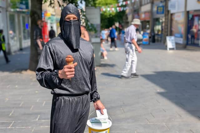 Rob enjoys an ice cream during his day dressed as a ninja.