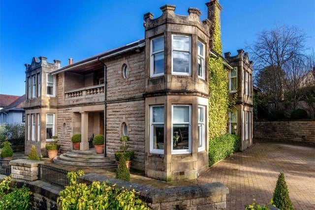 The drive way has space for several cars, and the house has a grand, sweeping staircase for a dramatic entrance.