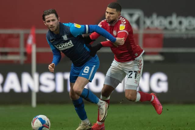 Preston North End's Alan Browne holds off the challenge from Bristol City's Nahki Wells.