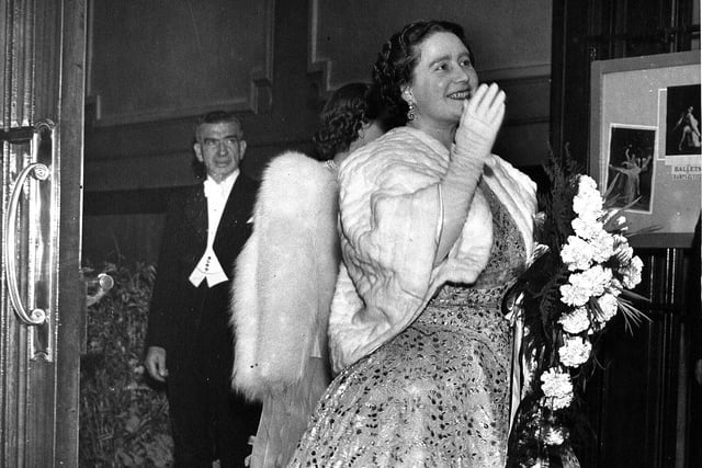 The Queen Mother in evening wear leaving the Empire Theatre, with manager Jimmy Hill in the background, in 1950.