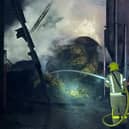 A brave firefighter tackles the blaze.