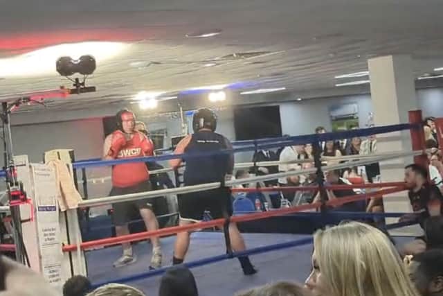 Joel in red in the ring during his fight night match