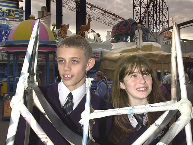 Ribbleton Hall High School pupils Charlene Flood and Ian Alty try their "Bog One" model for size in front of the real thing at Blackpool Pleasure Beach for the National Construction Week celebrations in 2001