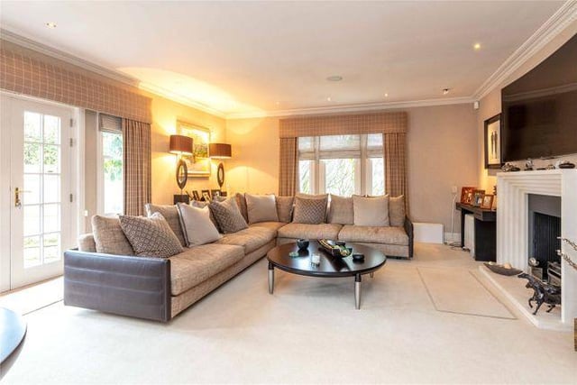 A large, light and airy livingroom with the grandest fire place in the house. It's huge.