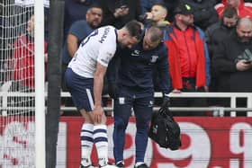 Preston North End's Greg Cunningham receives treatment for an injury