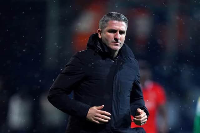Preston North End manager Ryan Lowe jogs across the pitch to the dressing room at half-time against Luton Town