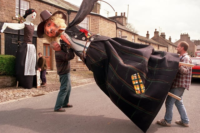 Dave Hartnup and Richard Bull put one of the giant scarecrows in place ready for the Wray Scarecrow Festival