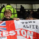 Three young North Enders with their flag in the away end at Pride Park