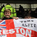 Three young North Enders with their flag in the away end at Pride Park