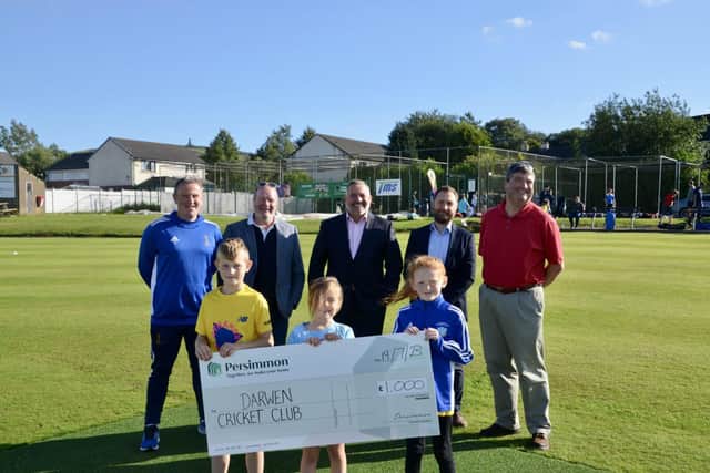 Members of Darwen CC welcome the donation from Persimmon representatives
