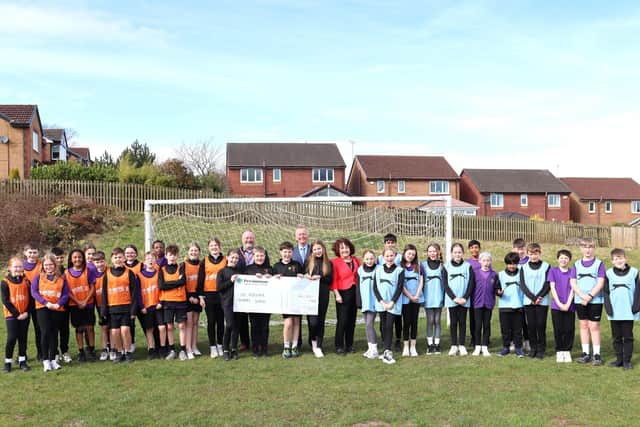 Pupils at the Redeemer School welcoming the cheque for £6,000