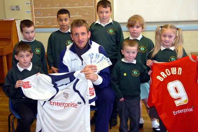 Preston North End's Chris Brown presents shirts and tickets at Brockholes Wood Primary School
