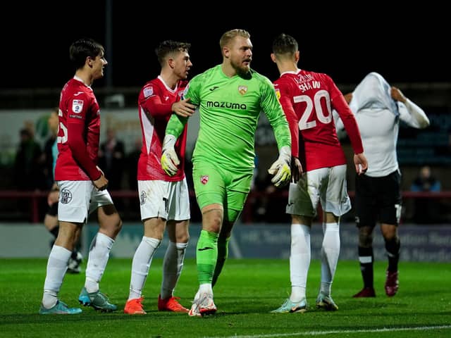 Morecambe goalkeeper Connor Ripley celebrates after saving a second penalty against Derby County