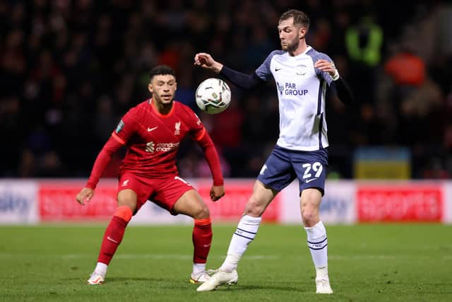 PRESTON, ENGLAND - OCTOBER 27: Alex Oxlade-Chamberlain of Liverpool looks on as Tom Barkhuizen of Preston North End controls the ball during the Carabao Cup Round of 16 match between Preston North End and Liverpool at Deepdale on October 27, 2021 in Preston, England. (Photo by Naomi Baker/Getty Images)
