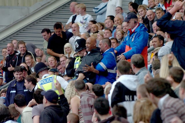 A Preston North End fan is removed from the Blackburn end during the Preston North End v Blackburn Rovers game in 2007