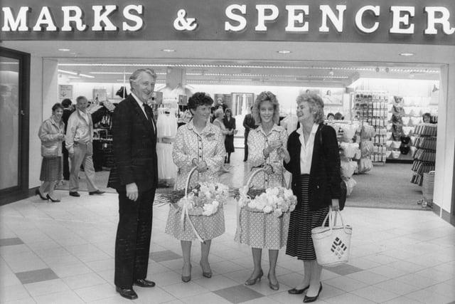 Offering flowers to shoppers entering the Marks & Spencer store in Fishgerate, Preston