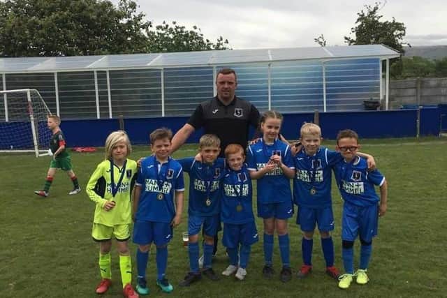 Padiham grassroots football coach Gaz Edwards with some of his players. Gaz has died suddenly at the age of 38