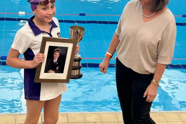 Charlotte Parker in Year 6, being presented the Magowan Gala trophy by Mrs Vivienne Magowan, William's mother. She presented the trophy.