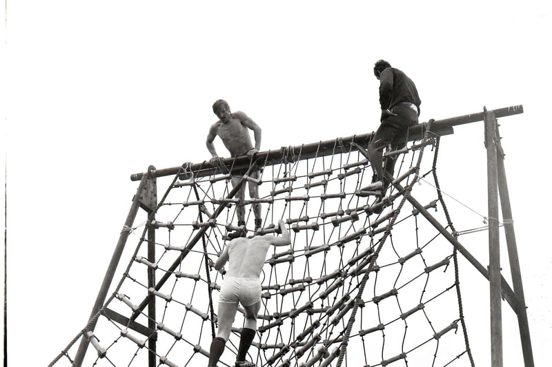 Gentlemen try they luck on the cargo net at the assualt course at Fulwood Barracks.
August 1971