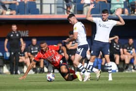 Preston North End's Andrew Hughes challenges Luton Town's Carlton Morris