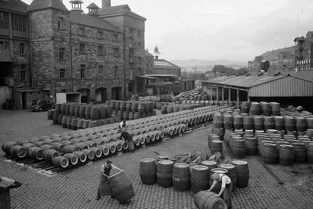 Workmen rolling barrels at Drybrough's Brewery, at Craigmillar, in August 1955. The brewery closed in 1987 and the site was subsequently demolished and replaced by flats.