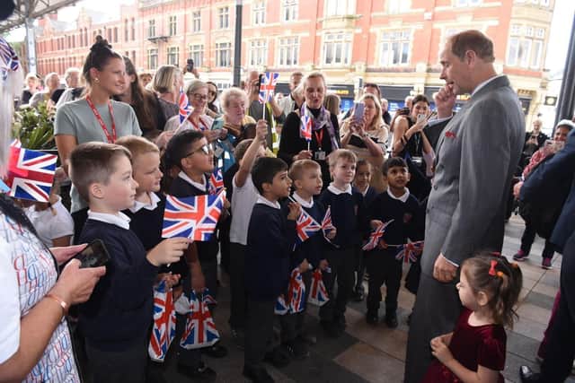 Prince Edward meets some youngsters on his visit to the city