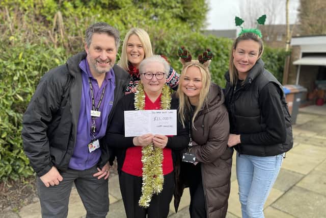 Derian House staff Mick Croskery, Kirsty Yates, Caroline Taylor and Sarah Proctor with lottery winner Joan Poole (centre)