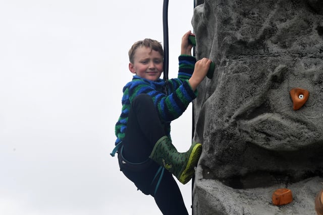A youngster enjoying the climbing wall at the show