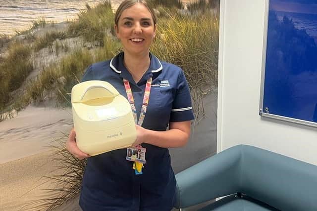 Paediatric nursing sister Amelia Conway with the milk thawing and warming device