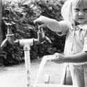 A child collects water from a stand pipe when the drought of 1976 kicked in