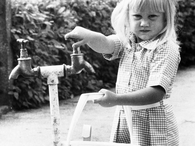 A child collects water from a stand pipe when the drought of 1976 kicked in