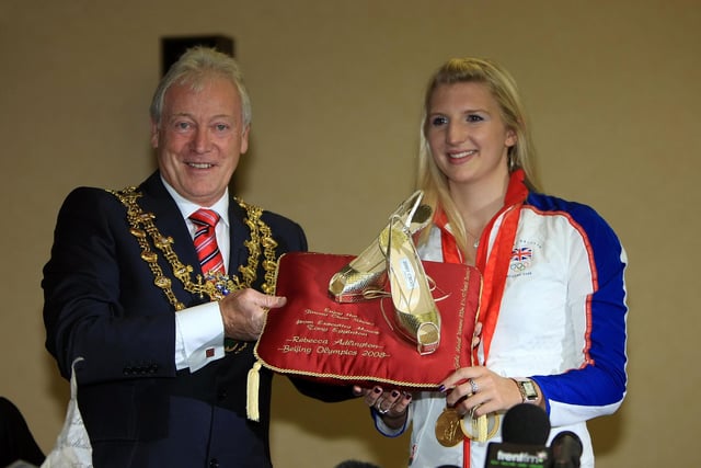 Double Olympic gold medal winning swimmer Rebecca Adlington smiles as she is given gold Jimmy Choo shoes by Mayor Tony Eggington.