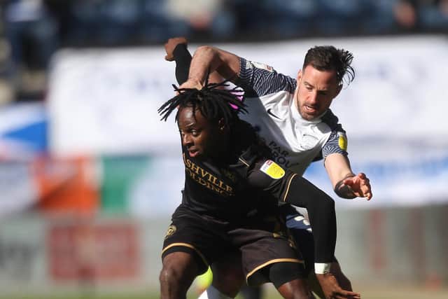 Preston North End left wing-back Greg Cunningham gets to grips with with Queens Park Rangers' Moses Odubajo
