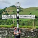 Karen's posing with an old signpost