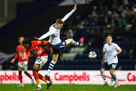 Preston North End's Liam Delap battles with Luton Town's Gabriel Osho