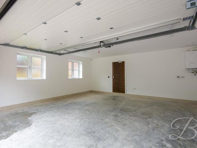 Here is surely the very definition of a proper garage. Huge, solid and capable of multiple uses.