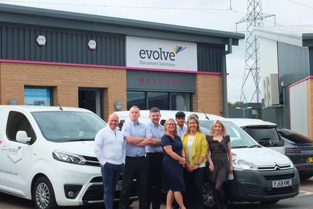 Evolve Document Solutions team outside their expanding office