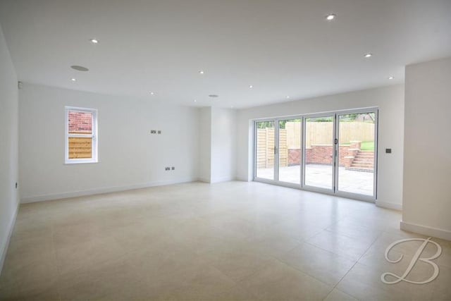 The open-plan kitchen is so large that it includes this area, which can be used as a dining room or living room. Bi-folding doors give convenient access to the back garden.