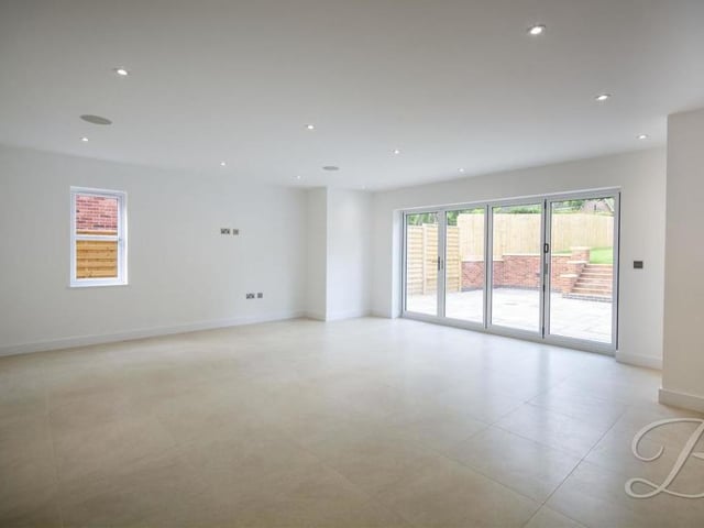 The open-plan kitchen is so large that it includes this area, which can be used as a dining room or living room. Bi-folding doors give convenient access to the back garden.